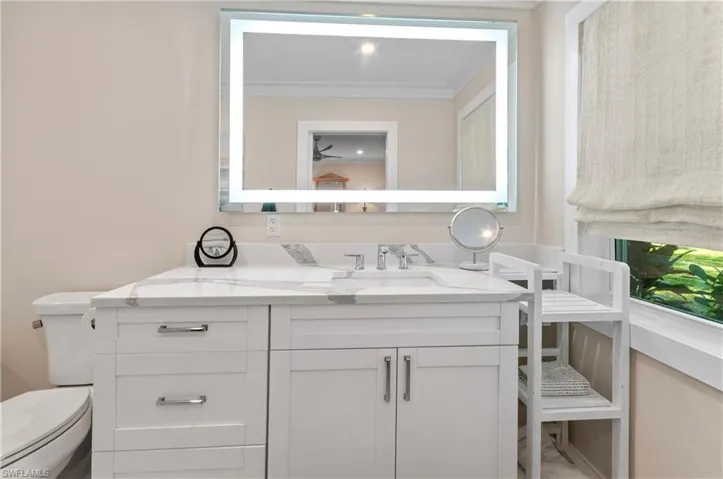 Bathroom with vanity and ornamental molding
