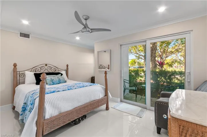 Bedroom with light tile patterned floors, access to exterior, a ceiling fan, and ornamental molding