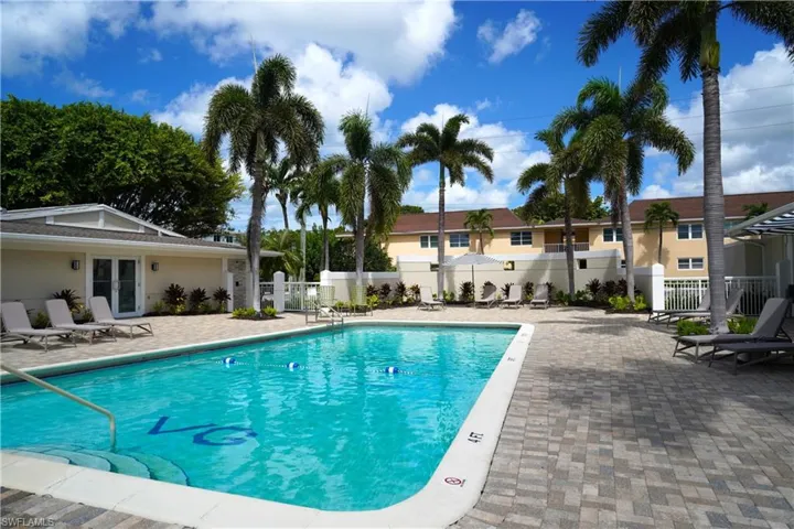 Community pool with a patio