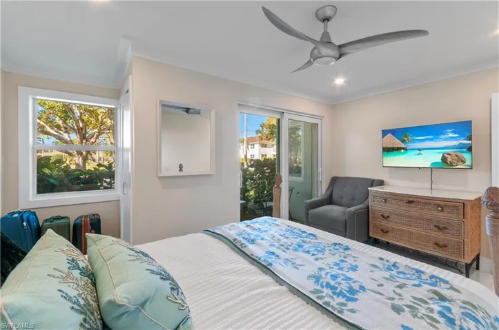 Bedroom featuring crown molding, access to exterior, and ceiling fan