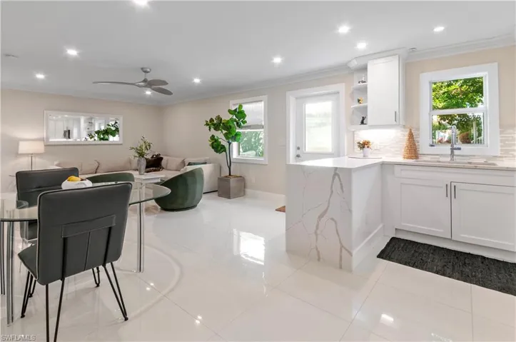 Dining room featuring crown molding, recessed lighting, and light tile patterned floors