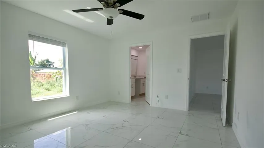 Unfurnished bedroom with baseboards, marble finish floor, and visible vents
