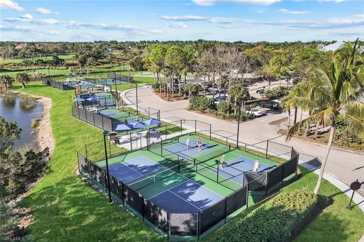 Multiple fenced pickleball courts with blue and green surfaces