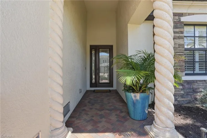 Covered entryway with textured stucco walls