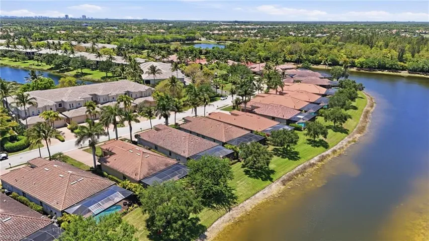 Aerial view of a residential community featuring waterfront properties with access to a large body of water