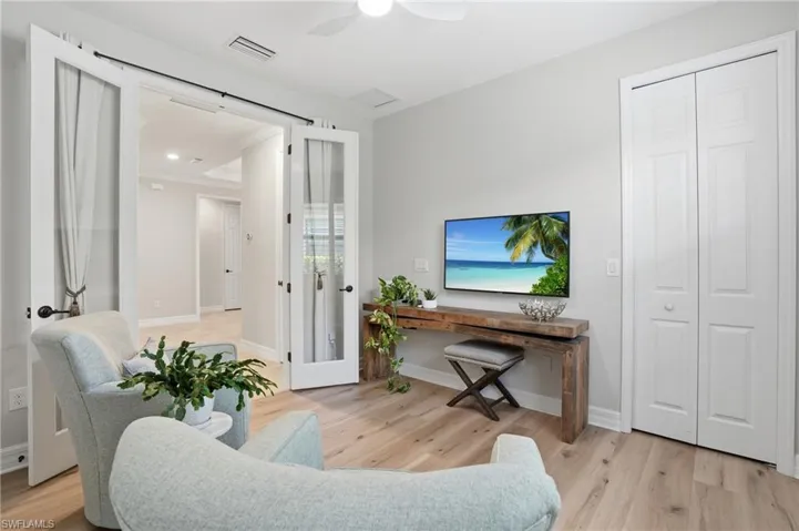 Light wood-finish flooring complements the neutral wall tones