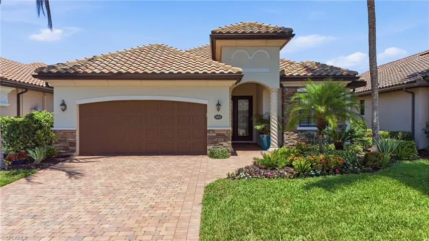 Mediterranean-inspired exterior featuring a barrel tile roof and stucco siding