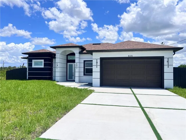 Single story home featuring driveway, a garage, stucco siding, and roof with shingles