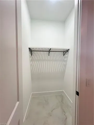 Spacious closet with marble look tiles