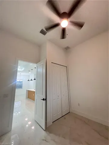 Unfurnished bedroom with a closet and a ceiling fan