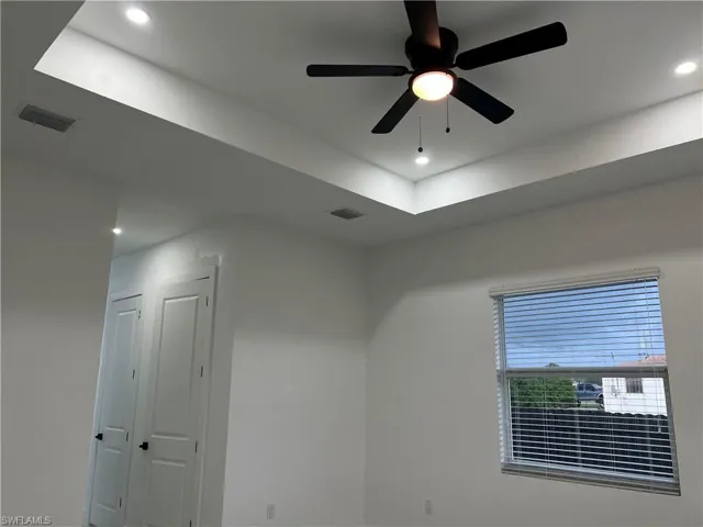 Detailed view of recessed lighting and a ceiling fan