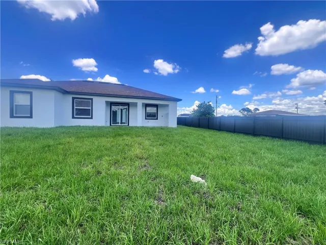 Rear view of property featuring stucco siding