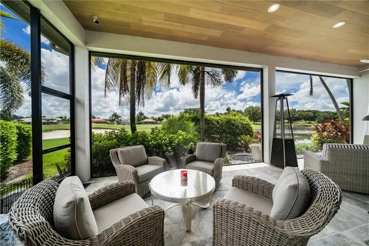 Rear lanai featuring wood plank ceiling and  golf course/water views
