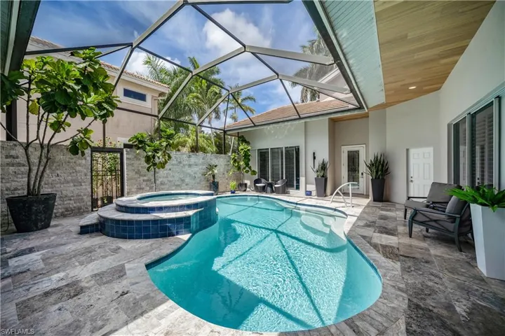 Gas heated Courtyard pool and spa with screened enclosure and patio area