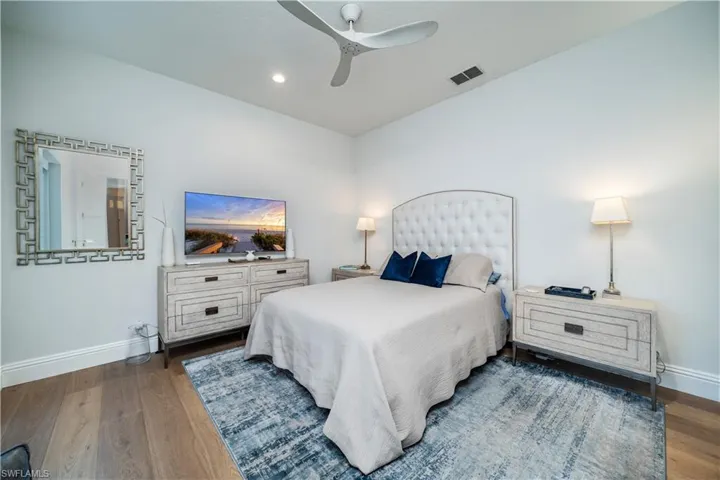 Bedroom featuring ceiling fan and dark hardwood / wood-style flooring