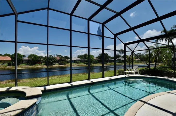View of pool featuring an in ground hot tub and a lanai