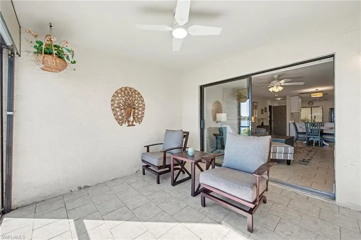 Lanai with porcelain tile, ceiling fan and manual hurricane shutters