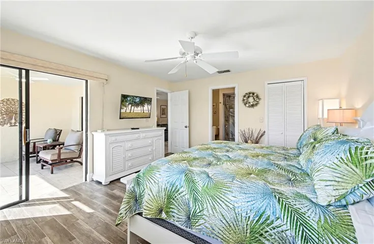 Primary bedroom has sliders open to lanai.