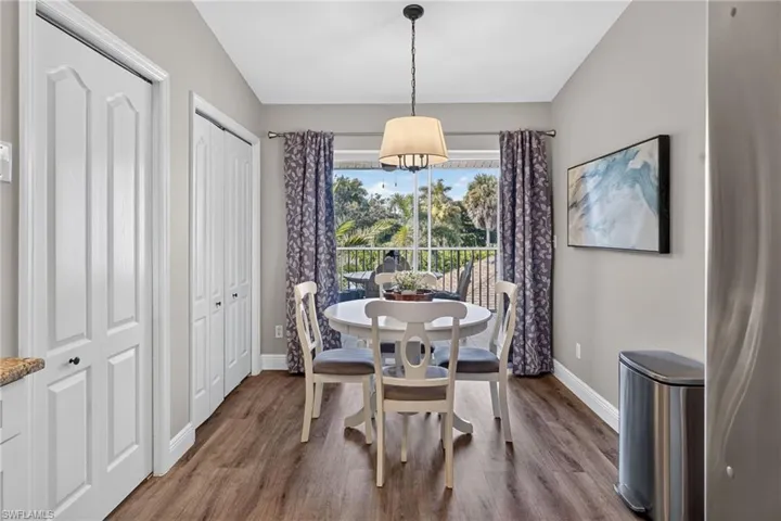 Wood-finish flooring, white paneled bifold doors, and a balcony with metal railings