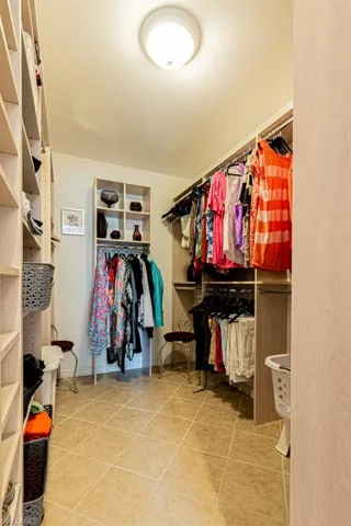 Spacious closet featuring tile patterned flooring