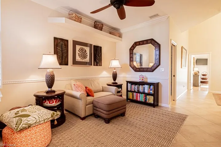 Sitting room with tile patterned flooring, crown molding, and ceiling fan