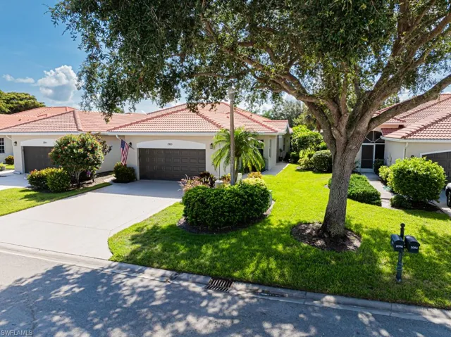 Mediterranean / spanish house featuring a garage and a front lawn