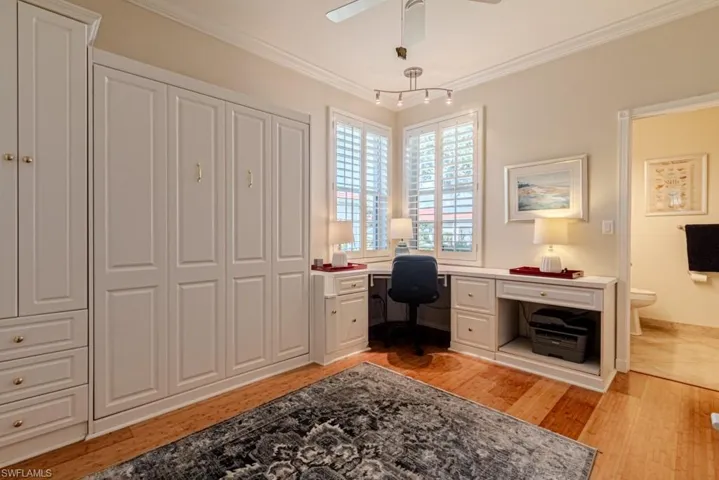 Office featuring light hardwood / wood-style flooring, ceiling fan, and crown molding