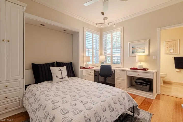 Bedroom featuring ornamental molding, light hardwood / wood-style flooring, and ceiling fan