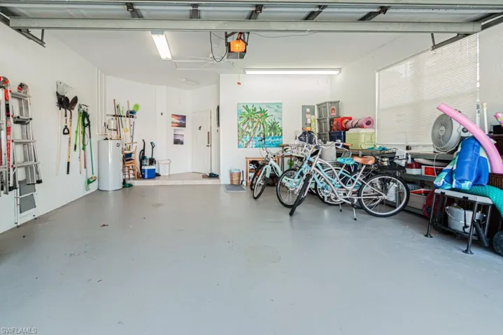 Garage with gas water heater and a garage door opener