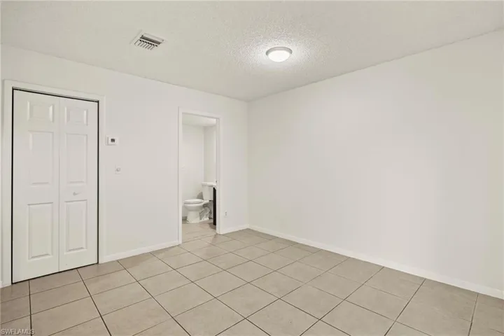 Light-colored tile flooring extending through the space