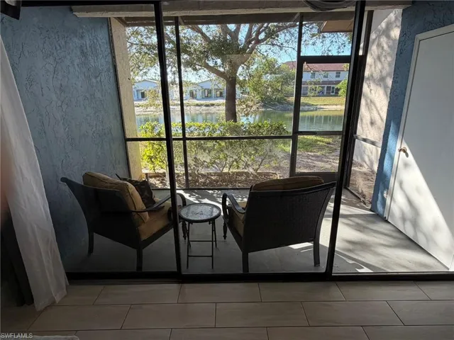 Sunroom / solarium featuring a water view and healthy amount of natural light