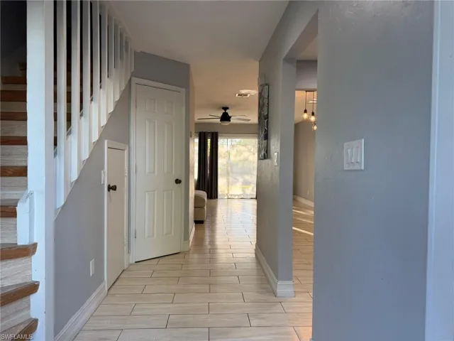 Hall with stairway and wood finish floors
