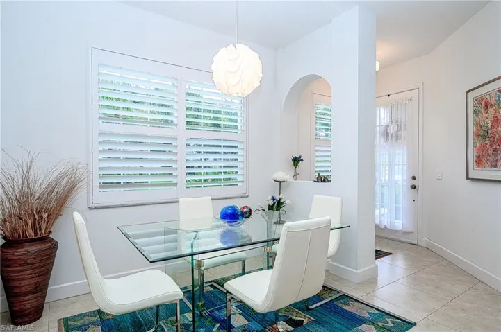 Dining area with a wealth of natural light and 18" light tile throughout home