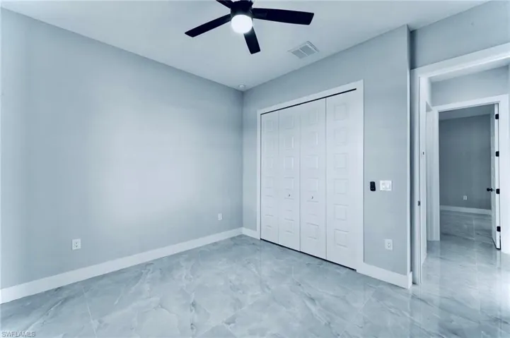 Unfurnished bedroom with a closet and ceiling fan