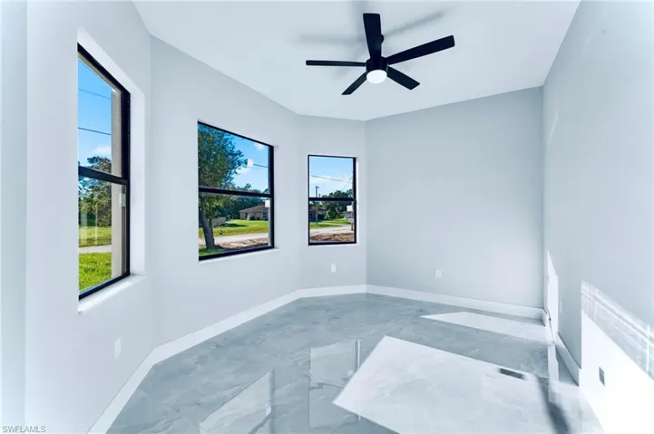 Spare room featuring marble tiled floors and ceiling fan