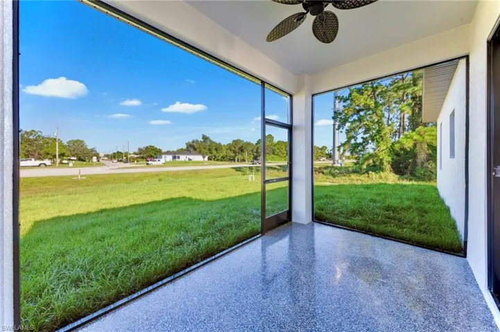 Unfurnished sunroom featuring speckle patterned floor