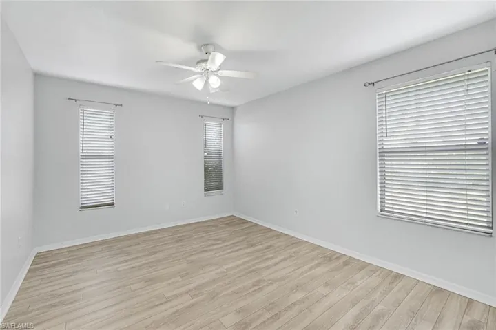 Empty room featuring light wood-style flooring and ceiling fan