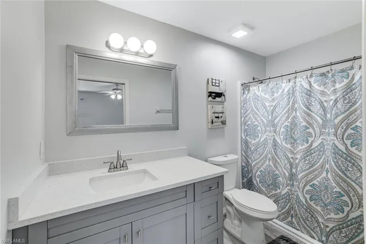 Full bathroom featuring vanity and a shower with curtain