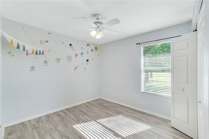Unfurnished room featuring light wood-type flooring and a ceiling fan