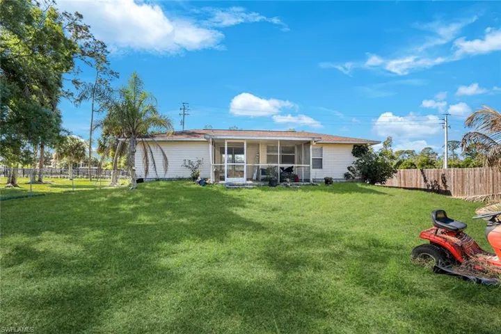 Back of house featuring a sunroom and a fenced backyard