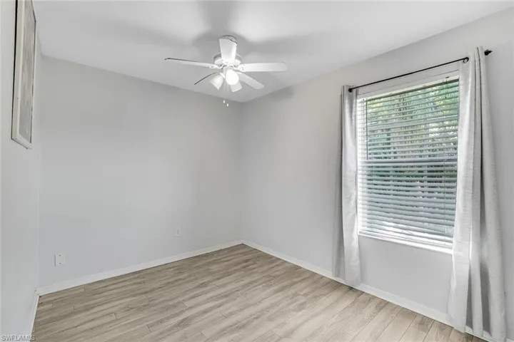 Empty room featuring ceiling fan and light wood-style floors