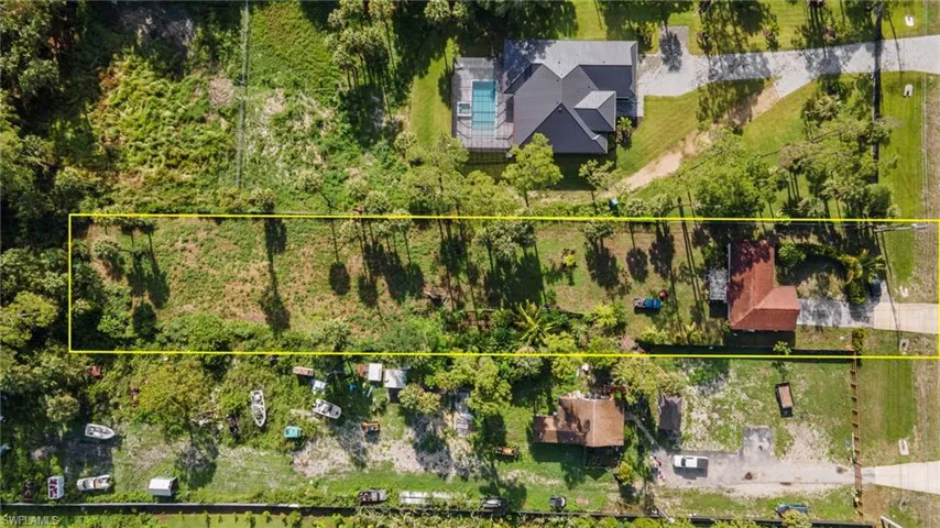 Aerial view of property and surrounding area featuring property boundaries highlighted