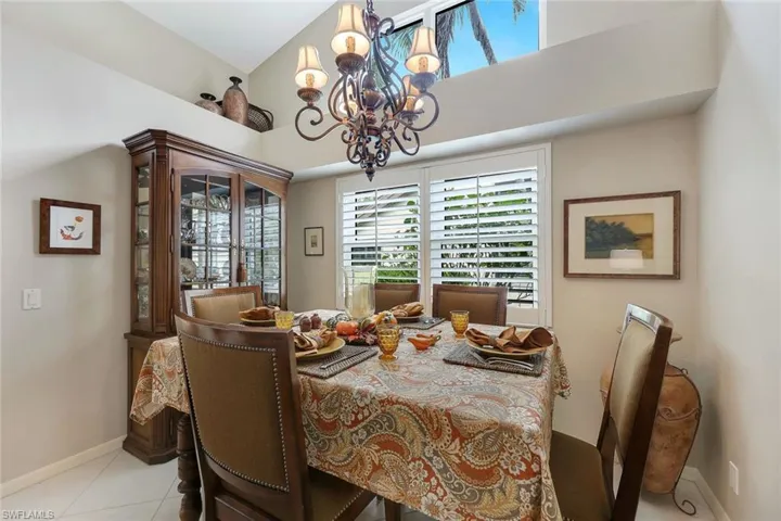 Tiled dining space with an inviting chandelier