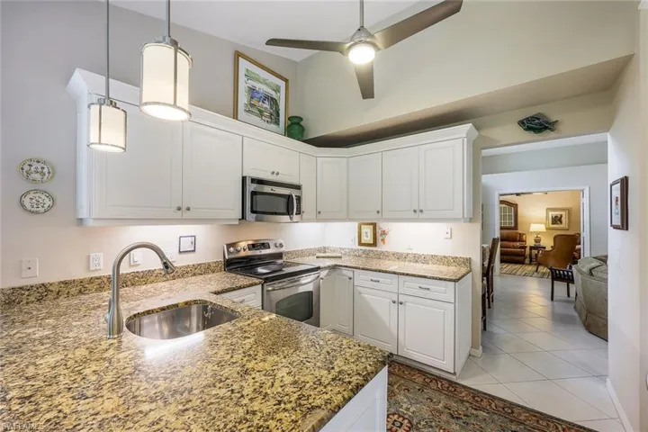 Kitchen featuring white cabinets, sink, and appliances with stainless steel finishes