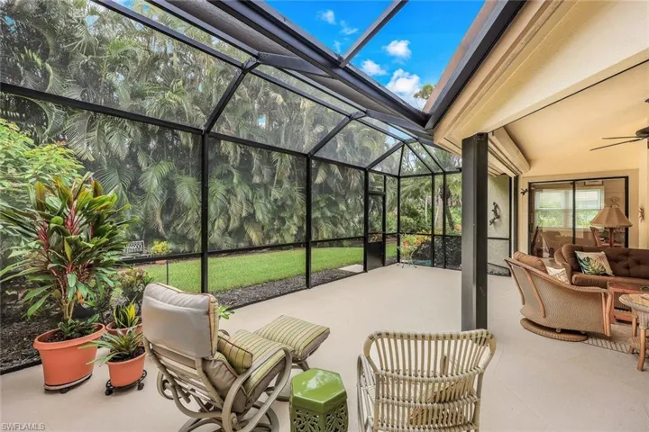 View of patio / terrace featuring glass enclosure and ceiling fan