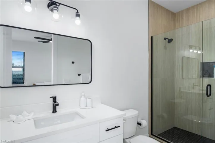 Bathroom featuring vanity and a stall shower - Virtually Edited Image
