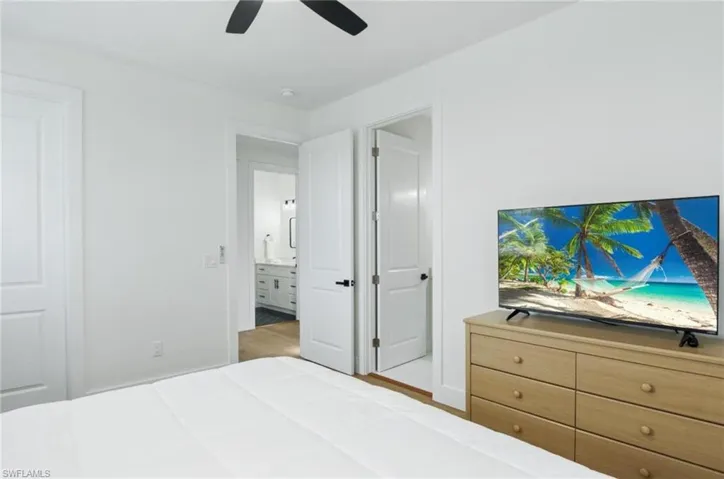 Bedroom with a ceiling fan and light wood-type flooring