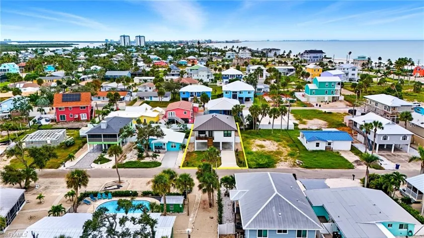 Aerial view of residential area featuring a nearby body of water - Virtually Edited Image