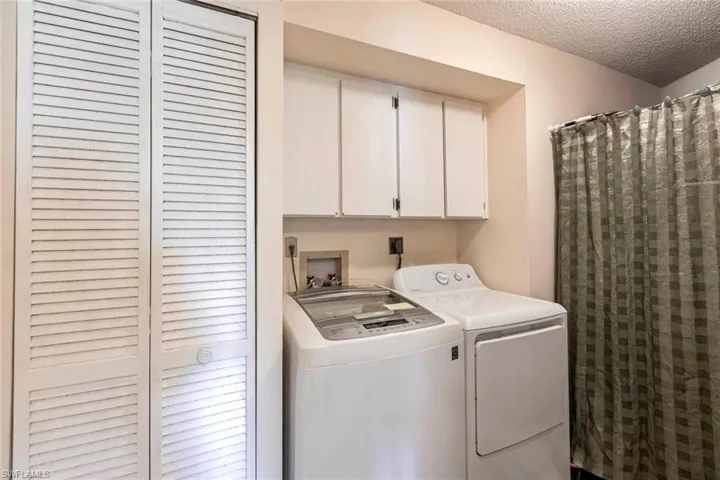Laundry room has cabinet space and storage space, washing machine, clothes dryer