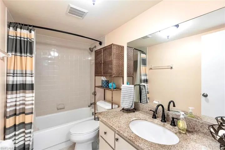 Guest bathroom featuring shower / bath combo and vanity